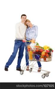 Young Woman and Man Standing Together Holding a Full Shopping Trolley with Purchases of Daily Products isolated on White Background