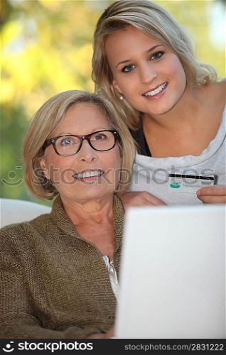 Young woman and senior woman doing shopping on Internet