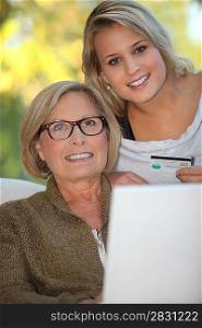 Young woman and senior woman doing shopping on Internet