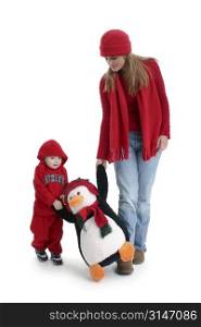 Young woman and toddler boy out shopping for toys. Walking with a giant stuffed pinquin. Shot in studio.