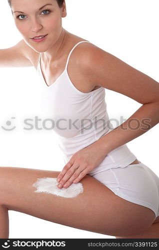 Young woman applying cream, focus on hand and leg