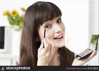 Young Woman Applying Eye Make Up At Home