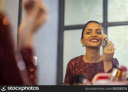 Young woman applying make-up in front of mirror