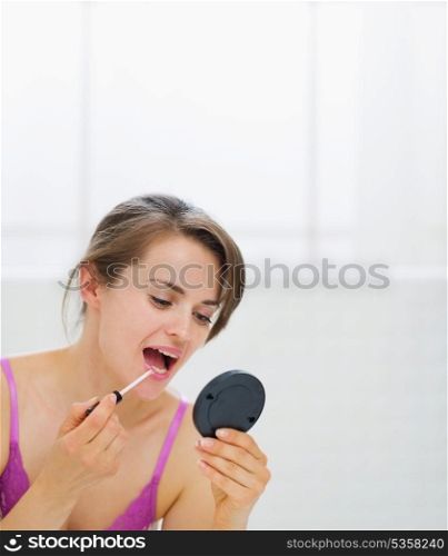 Young woman applying makeup