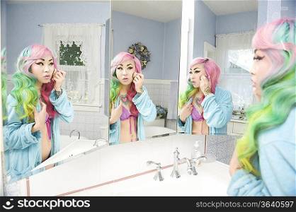 Young woman applying makeup with multiple mirror reflections