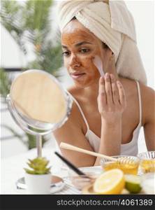 young woman applying natural face mask 2