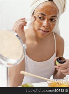 young woman applying natural face mask 3