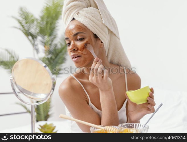 young woman applying natural face mask