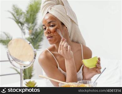 young woman applying natural face mask
