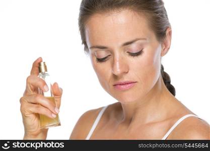 Young woman applying perfume