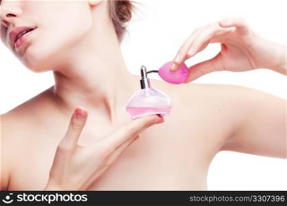 Young woman applying perfume on herself isolated on white background