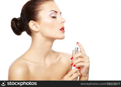 Young woman applying perfume on herself isolated on white background. Fashion photo