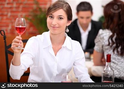 Young woman appreciating a glass of rose wine