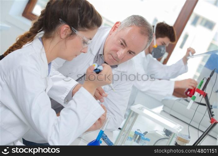 young woman apprentice testing in a lab