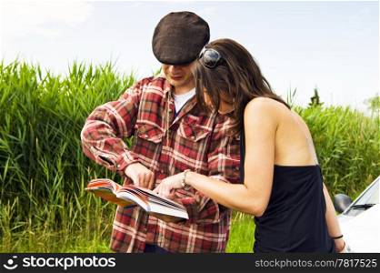 Young woman asking a farmer for advice on where to go, consulting a guide book