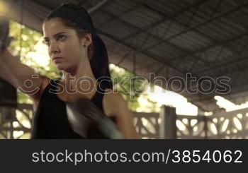Young woman at boxing and self defense course in fitness gym