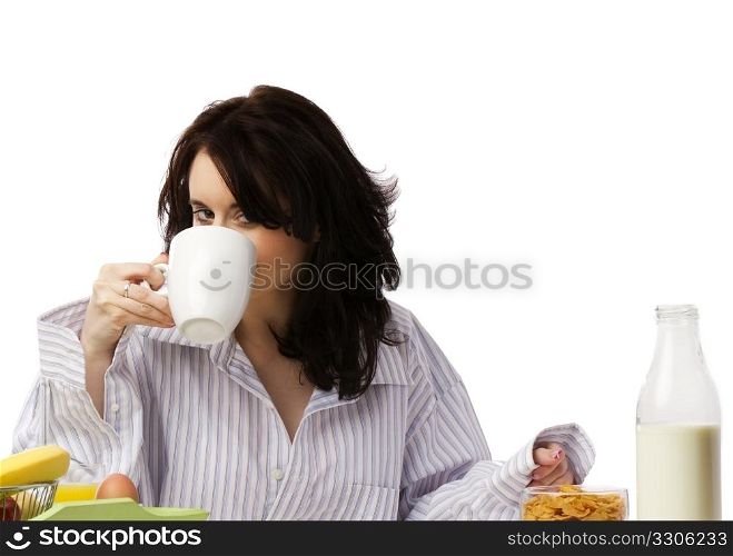 young woman at breakfast drinking coffee. young beautiful woman at breakfast drinking coffee
