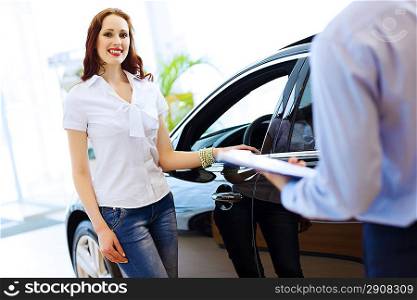 Young woman at car salon