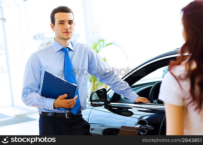 Young woman at car salon