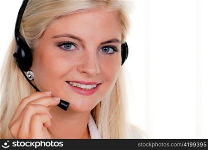 young woman at computer with headset and hotline.