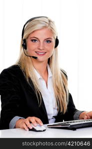 young woman at computer with headset and hotline.