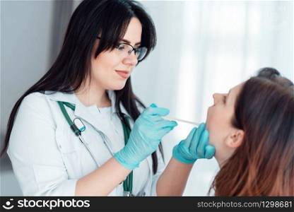 Young woman at family doctor reception in clinic. Specialist examines female patient, professional health care. Young woman at family doctor reception