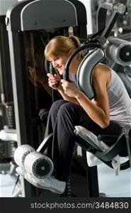 Young woman at fitness center exercise abdominal muscle gym machine