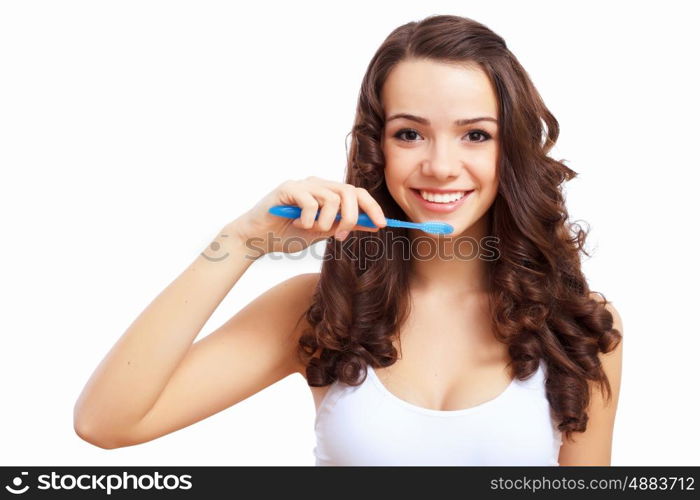 Young woman at home brushing teeth in the morning