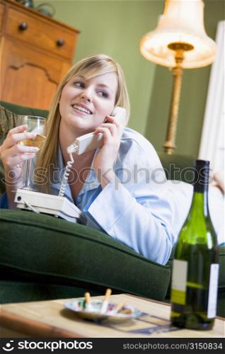 Young woman at home talking on telephone