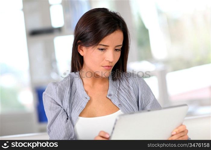 Young woman at home using electronic tablet