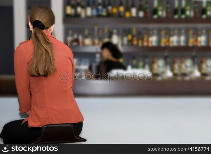 Young woman at the bar counter