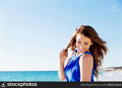Young woman at the beach. Portrait of young pretty woman on summer day on the beach
