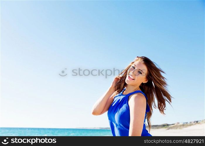 Young woman at the beach. Portrait of young pretty woman on summer day on the beach