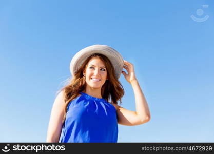 Young woman at the beach. Portrait of young pretty woman wearing hat at the beach