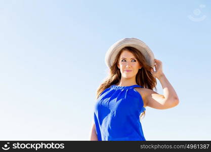 Young woman at the beach. Portrait of young pretty woman wearing hat at the beach