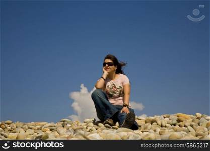 young woman at the beach with the sky as background