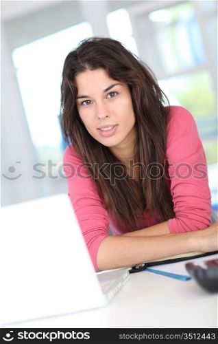 Young woman at work in front of laptop computer