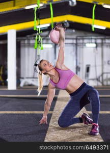 young woman athlete exercise with fitness kettlebell at crossfitness gym. woman exercise with fitness kettlebell