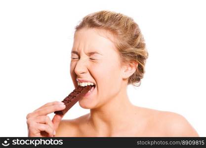 Young woman biting chocolate bar isolated on white