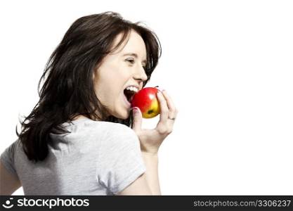 young woman biting in red apple. young happy woman eating red apple