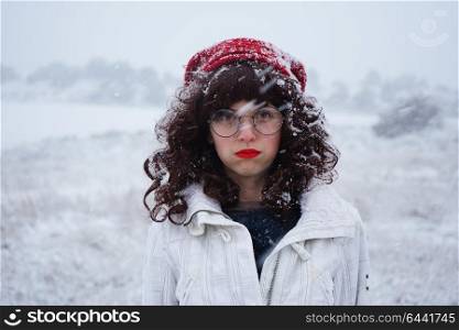 Young woman bored in a snowy day