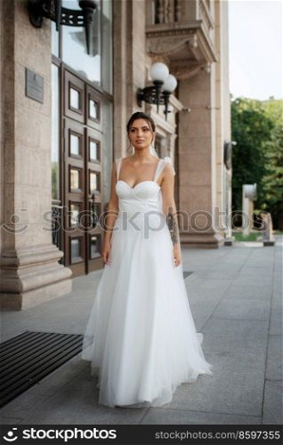 young woman bride in white dress in urban atmosphere