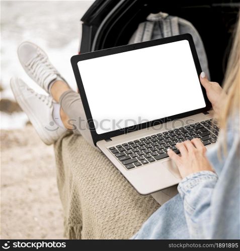 young woman browsing laptop on road trip. Resolution and high quality beautiful photo. young woman browsing laptop on road trip. High quality and resolution beautiful photo concept