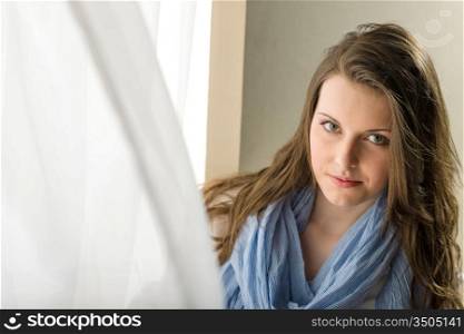 Young woman brunette stand behind blowing curtain romantic purity