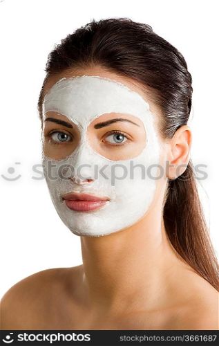 young woman brunette with during a treatment with a beauty mask on her face