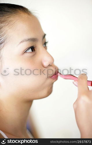 Young woman brushing teeth