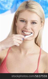 Young Woman Brushing Teeth In Studio