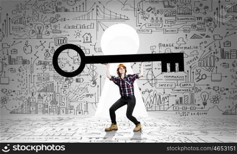 Young woman builder and keyhole at background lifting big key above head. Find key to success