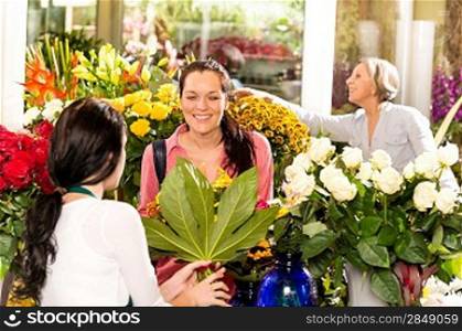 Young woman buying bouquet flower shop colorful customer