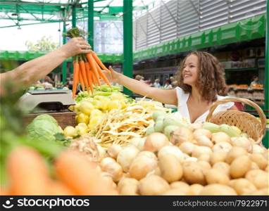 Young Woman Buying Carrots at Grocery Market